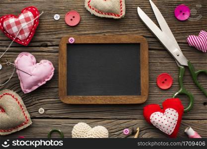 empty chalkboard surrounded by haberdashery accessories