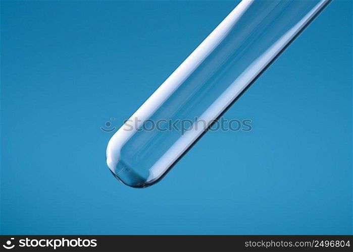 Empty clean clear laboratory big glass test tube on blue background