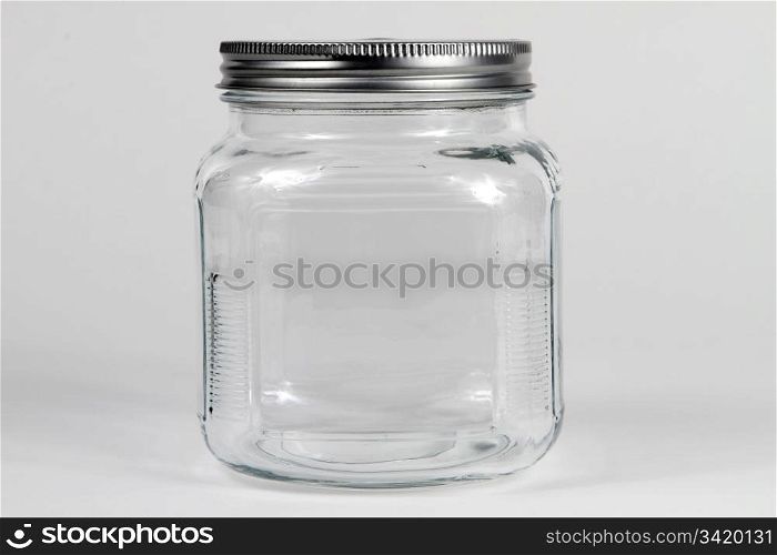 Empty clear glass jar with screw lid.