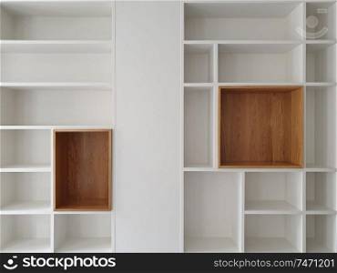 Empty closet shelves background. Modern wooden wardrobe boxes, beautiful white and brown interior design combination, abstract shape and patterns.