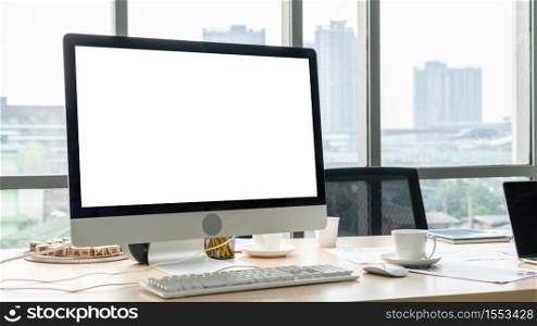 Empty computer monitor screen for design mock up template in modern small office interior or home office. Stylish workplace for creative occupation.