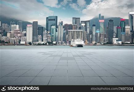 Empty concrete cement floor with sea and cityscape skyline , morning scene .