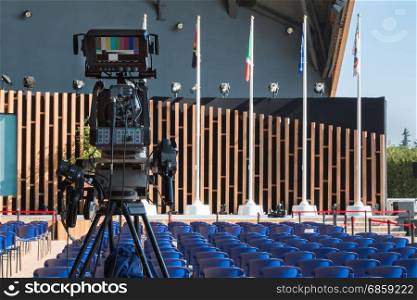 Empty Conference Room with Television Camera Ready for Audience
