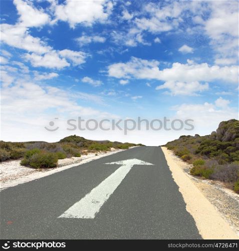 Empty countryside road with white arrow sing on it