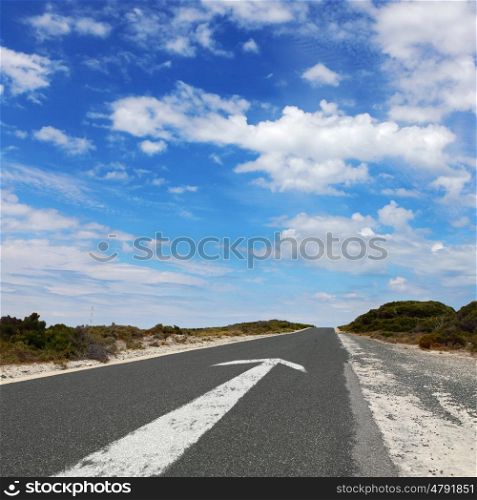 Empty countryside road with white arrow sing on it