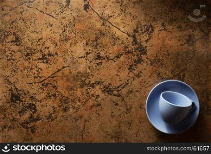 empty cup and saucer at abstract background