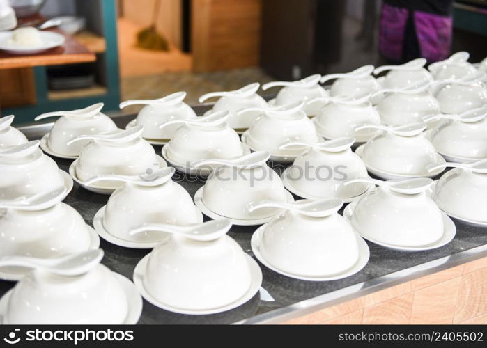 empty cup and spoon on the table, white cup bowl ready to serve for soup