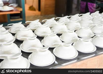 empty cup and spoon on the table, white cup bowl ready to serve for soup