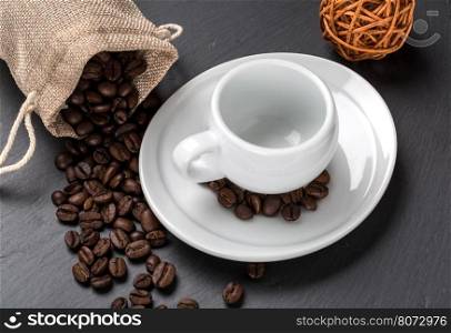 Empty cup of coffee with beans as background. Empty cup of coffee with coffe beans as background