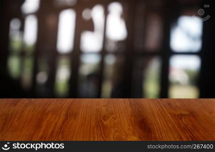 Empty dark wooden table in front of abstract blurred background of cafe and coffee shop interior. can be used for display or montage your products - Image