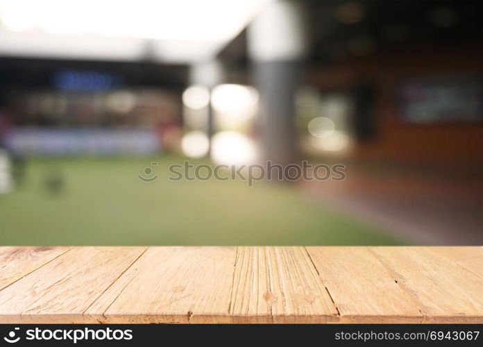 Empty dark wooden table in front of abstract blurred background of cafe and coffee shop interior. can be used for display or montage your products