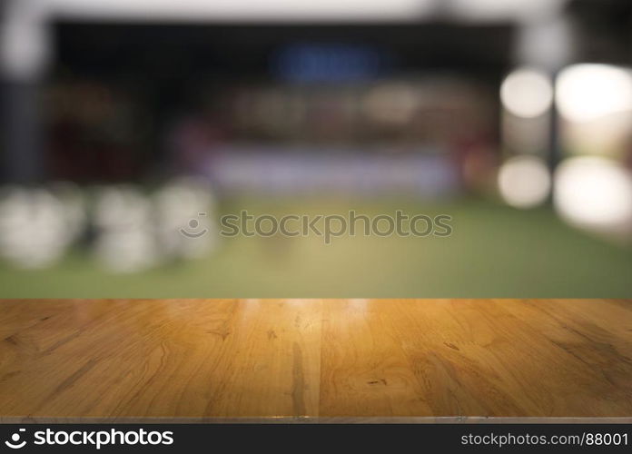 Empty dark wooden table in front of abstract blurred background of cafe and coffee shop interior. can be used for display or montage your products