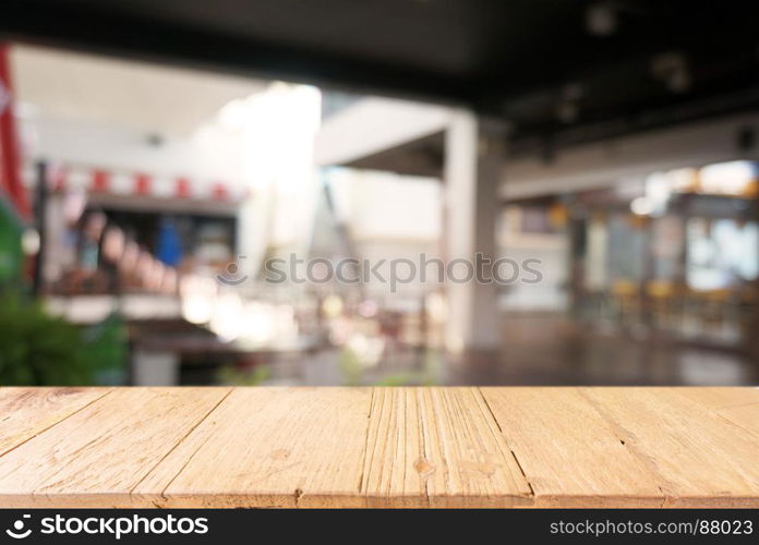 Empty dark wooden table in front of abstract blurred background of cafe and coffee shop interior. can be used for display or montage your products