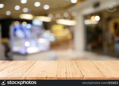 Empty dark wooden table in front of abstract blurred background of cafe and coffee shop interior. can be used for display or montage your products.