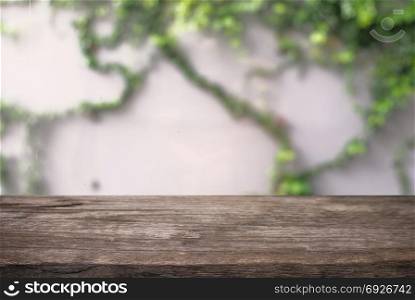 Empty dark wooden table in front of abstract blurred background of outdoor garden lights interior. can be used for display or montage your products