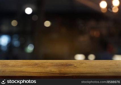 Empty dark wooden table in front of abstract blurred background of restaurant, cafe and coffee shop interior. can be used for display or montage your products - Image