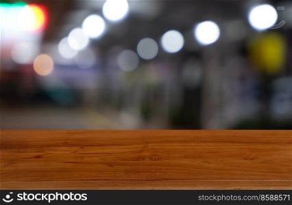 Empty dark wooden table in front of abstract blurred background of restaurant, shopping mall interior. can be used for display or montage your products - Image 