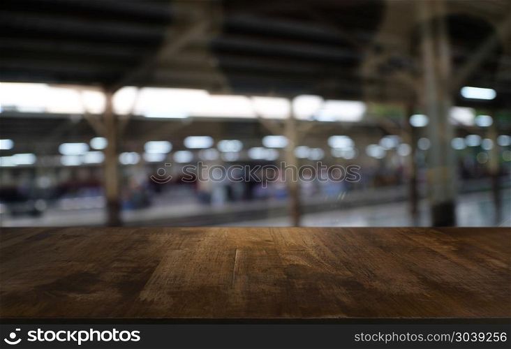 Empty dark wooden table in front of abstract blurred bokeh backg. Empty dark wooden table in front of abstract blurred bokeh background of restaurant . can be used for display or montage your products.Mock up for space