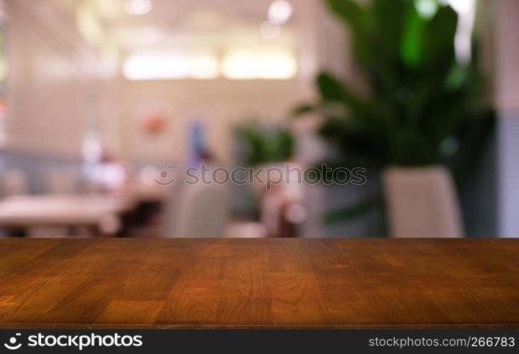 Empty dark wooden table in front of abstract blurred bokeh background of restaurant . can be used for display or montage your products.Mock up for space