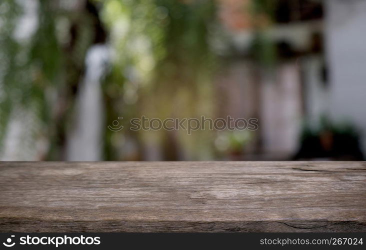 Empty dark wooden table in front of abstract blurred bokeh background of restaurant . can be used for display or montage your products.Mock up for space