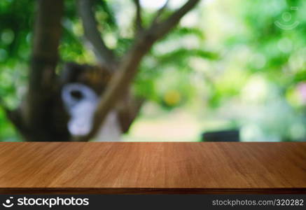 Empty dark wooden table in front of abstract blurred bokeh background of restaurant . can be used for display or montage your products.Mock up for space