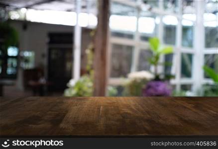 Empty dark wooden table in front of abstract blurred bokeh background of restaurant . can be used for display or montage your products.Mock up for space