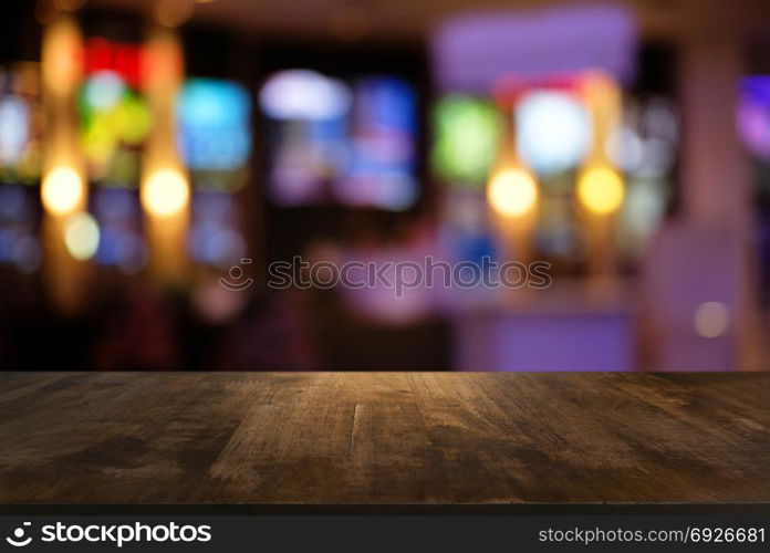 Empty dark wooden table in front of abstract blurred bokeh background of restaurant . can be used for display or montage your products.Mock up for space