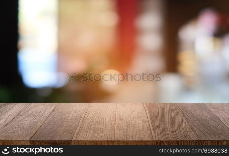 Empty dark wooden table in front of abstract blurred bokeh background of restaurant . can be used for display or montage your products.Mock up for space