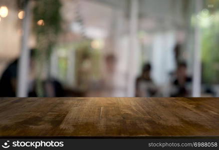 Empty dark wooden table in front of abstract blurred bokeh background of restaurant . can be used for display or montage your products.Mock up for space