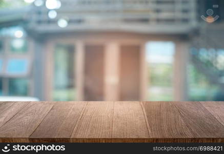 Empty dark wooden table in front of abstract blurred bokeh background of restaurant . can be used for display or montage your products.Mock up for space