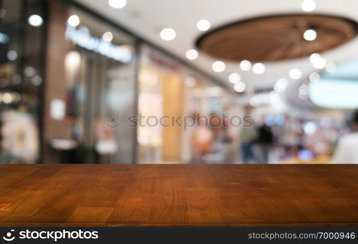 Empty dark wooden table in front of abstract blurred bokeh background of restaurant . can be used for display or montage your products.Mock up for space