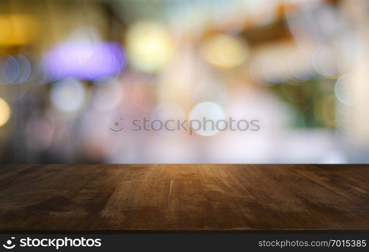 Empty dark wooden table in front of abstract blurred bokeh background of restaurant . can be used for display or montage your products.Mock up for space 