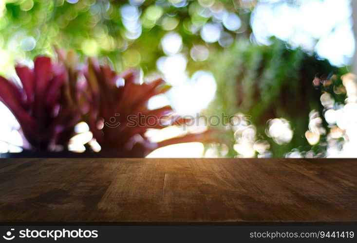 Empty dark wooden table in front of abstract blurred bokeh background of restaurant . can be used for display or montage your products.Mock up for space 