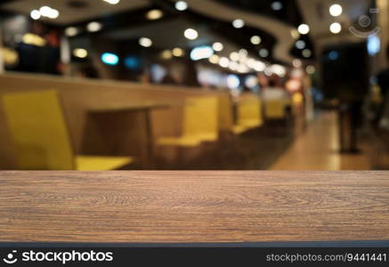 Empty dark wooden table in front of abstract blurred bokeh background of restaurant . can be used for display or montage your products.Mock up for space 