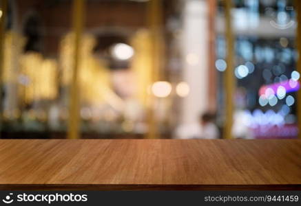 Empty dark wooden table in front of abstract blurred bokeh background of restaurant . can be used for display or montage your products.Mock up for space 