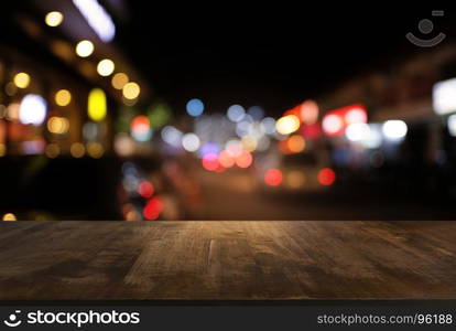 Empty dark wooden table in front of abstract blurred bokeh background of restaurant . can be used for display or montage your products.Mock up for space