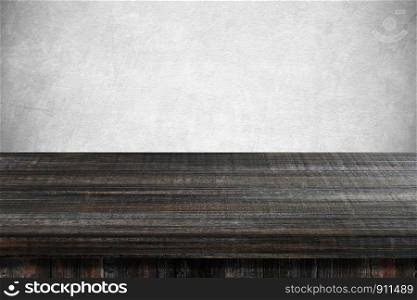 Empty dark wooden table over gray cement wall, vintage, background, template, product display montage
