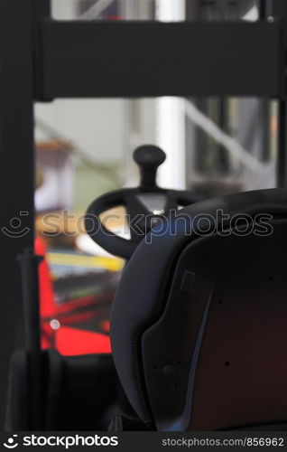 Empty driver seat in a forklift truck.