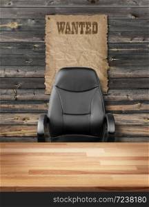 Empty executive chair in front of a rough wall with wanted poster