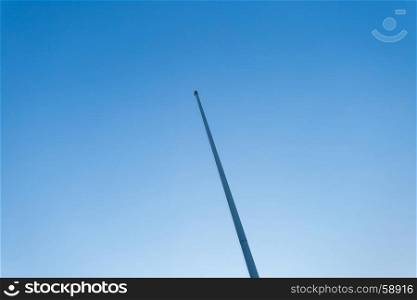 empty flagstaff on blue sky