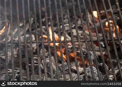 Empty flaming charcoal grill with open fire, ready for steak preparation barbecue concept with selective focus.. Empty flaming charcoal grill with open fire, ready for steak preparation barbecue concept with selective focus.