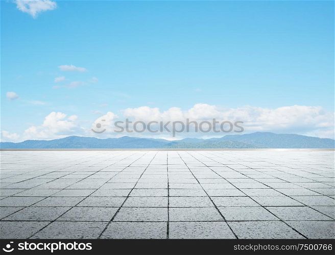 Empty floor in front of blue sky .