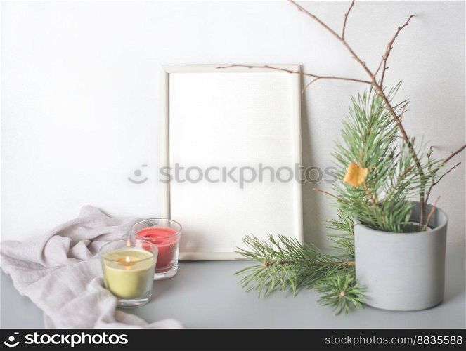 empty frame with copy space. winter still life with glowing candles and pine tree branches in cement flowerpot. place for inspirational text. winter season mood. empty frame with copy space. winter still life with glowing candles and pine tree branches in cement flowerpot. place for inspirational text. winter season mood.