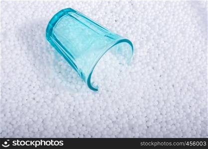 Empty glass on little white polystyrene foam balls