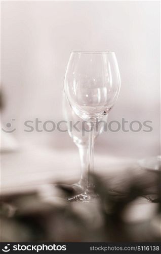 Empty glass set in restaurant. wedding, decor, celebration, holiday concept - romantic table setting with white tablecloth, plates, crystal glasses.. Empty glass set in restaurant. wedding, decor, celebration, holiday concept - romantic table setting with white tablecloth, plates, crystal glasses