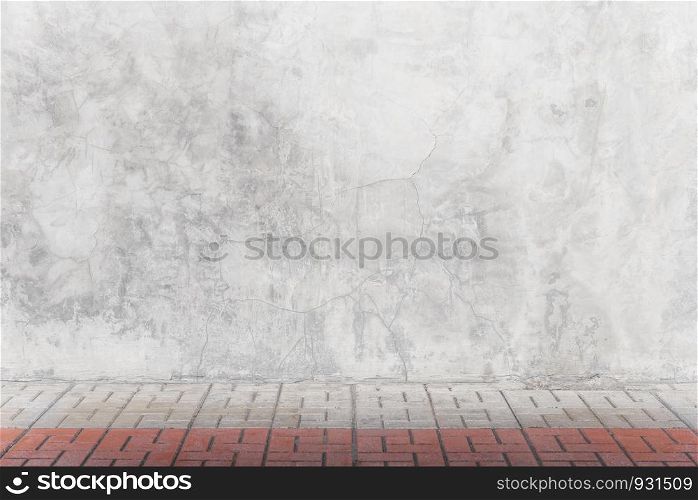 Empty grey concrete wall with bricks floor in room. Abstract background or backdrop.