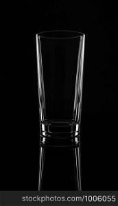 Empty high glass, isolated on a black background.. Empty high glass, isolated on a black background