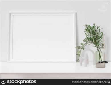 Empty horizontal picture frame standing on white shelf. Frame mock up. Copy space for picture, poster. Template for your artwork. Close up view. Plant in vase, home accessories, sculpture. 3D render. Empty horizontal picture frame standing on white shelf. Frame mock up. Copy space for picture, poster. Template for your artwork. Close up view. Plant in vase, home accessories, sculpture. 3D render.