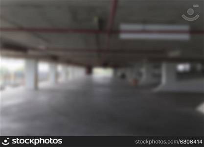 empty indoor car parking lot in building - blur for background