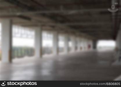 empty indoor car parking lot in building - blur for background